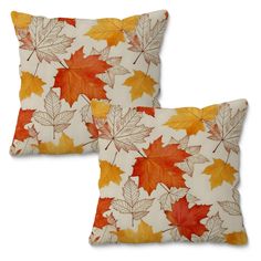 two pillows with autumn leaves on them