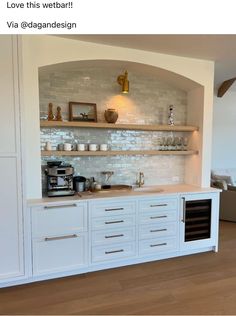 a kitchen with white cabinets and open shelving on the wall above it is shown