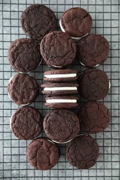 chocolate cookies and marshmallows are arranged on a cooling rack, ready to be eaten