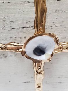 the cross is made out of wood and has an eyeball in it's center