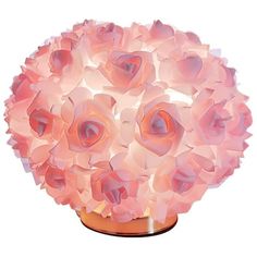 a vase filled with pink flowers sitting on top of a table