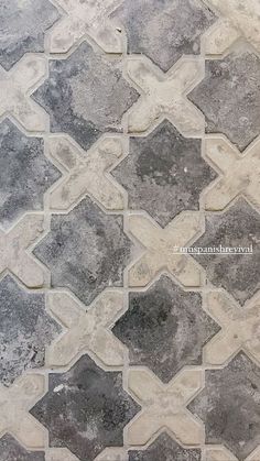 a tile floor with grey and white tiles on it's sides, in the shape of hexagonals