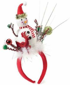 a red headband with a snowman and reindeer decoration on it's side