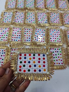 some gold and white dots are arranged in rows on top of each other, with different colors