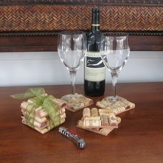 two wine glasses and some corks on a table