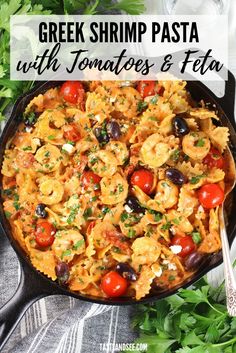 greek shrimp pasta with tomatoes and feta in a cast iron skillet next to fresh parsley