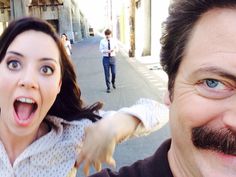 a man and woman taking a selfie in the street