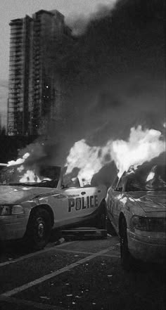 two police cars are on fire in the city