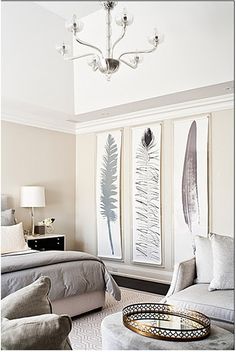 a living room filled with furniture and a chandelier hanging from the ceiling over a bed