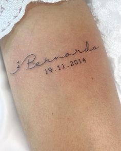 the back of a woman's arm with a tattoo that reads, benarada 19 11 2014