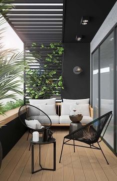 an outdoor living area with black and white furniture