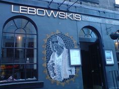 a building with a mural on the side of it that says lebowskis