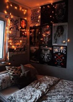 a bedroom with lights and posters on the wall