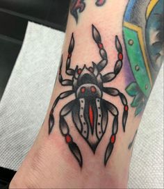 a tattoo on the foot of a person with a crab and shield in the background