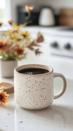 a cup of coffee sitting on top of a white counter