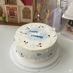 a birthday cake sitting on top of a table next to other toys and decorations in the background