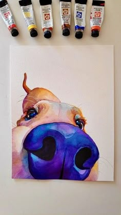 a painting of a dog's face with five paint tubes next to it