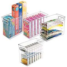 four clear storage bins with labels on the front and bottom, each containing different types of food