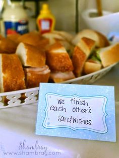 a table topped with lots of different types of sandwiches