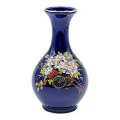 a blue vase with flowers painted on the side and wheels in the middle, sitting against a white background