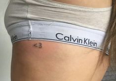 a close up of a person's stomach with a name tattoo on it