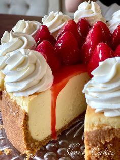 a cheesecake with strawberries and whipped cream on top sits on a glass platter