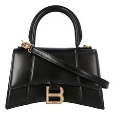 Dimensions: L 18,8 X H 13 X B 7,9 Cm
 Shiny Box Calfskin
 Hourglass Shape
 Curvilinear Base
 Long Flap
 Adjustable And Removable Crossbody Strap (55 Cm)
 1 Handle
 Handle Drop 9 Cm
 Magnet Closure With Aged-Gold B Logo (Brass)
 1 Back Pocket
 Nappa Lambskin Lining
 Made In Italy
Material: Calfskin Balenciaga Hourglass Bag, Balenciaga Top Handle Bag, Balenciaga Clutch, Balenciaga Neo Classic, Balenciaga Tote, B Logo, Balenciaga Leather, Balenciaga Women, Balenciaga Black