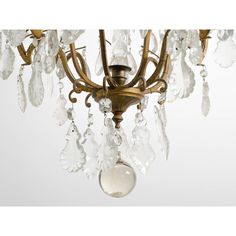 an antique chandelier with glass drops hanging from it's arms and two lights on each side