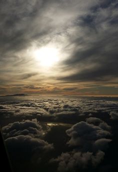 the sun is shining through some clouds in the sky