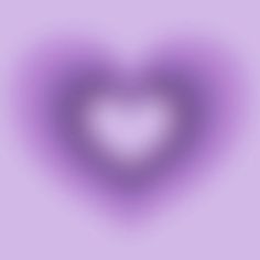 a blurry image of a heart shaped object on a purple background with room for text