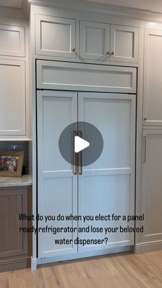 a kitchen with white cabinets and wood flooring is featured in the video titled what do you do when you electt for a panel remodel