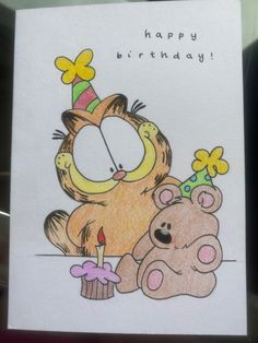 a happy birthday card with a cartoon cat and teddy bear holding a candle in its mouth