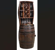 an old wooden barrel with wine glasses on top and shelves in the middle, sitting against a black background