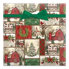 a christmas wrapping paper with red barns and evergreens on it is wrapped in green ribbon