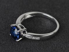 Welcome to my shop, you can find many beautiful gemstone jewelry here, and you also can ask for customized service. Main Stone: lab created sapphire, round cut, measures 7X7mm, weight about 1.64 carats.Accent Stones: czMetal: 925 sterling silver plated with rhodium. I also can provide metal options such as 14k solid yellow/white/rose goldSetting: prong settingmore rings: https://www.etsy.com/shop/XCjewelryStudio?ref=hdr_shop_menuIt's a perfect gift for the person who was born in September (Birth Sapphire Topaz Round Ring For Promise, Sapphire Topaz Promise Ring, Sapphire Topaz Ring For Promise, Sapphire Birthstone Ring With Round Stone, Sterling Silver Sapphire Ring With Round Cut, Formal Round Sapphire Birthstone Ring, Formal Sapphire Birthstone Ring, Sapphire Solitaire Birthstone Ring, Round Sapphire Solitaire Birthstone Ring