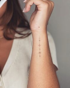 a woman with a small star tattoo on her arm