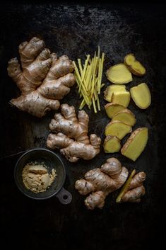 the ingredients for this recipe include ginger, ginger powder and ginger root slices on a black surface