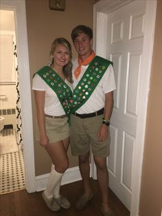 a man and woman are dressed up for st patrick's day in front of the door