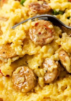 sausage and macaroni casserole on a plate with a fork in it