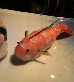 a piece of sushi on a white plate