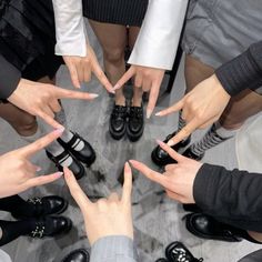 several people standing in a circle with their hands together