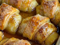 baked pastry items in a baking dish with syrup on top, ready to be eaten