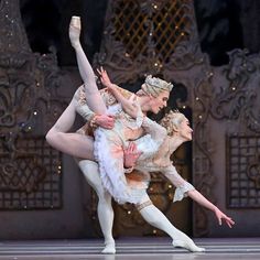 two ballerinas are performing on stage together