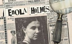 a magnifying glass sitting on top of a newspaper with an image of a woman