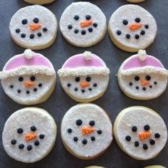 frosted cookies decorated like snowmen with hats and carrots