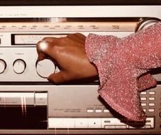 a person's hand on top of an old radio