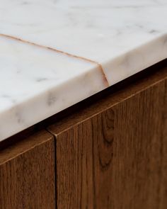 a marble counter top sitting on top of a wooden cabinet