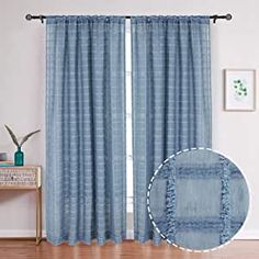 the curtains in this room are blue and have ruffles on them, along with a plant