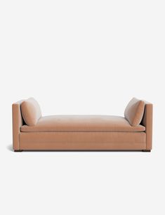 a tan couch sitting on top of a white floor