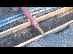 a person is working on some kind of wooden structure that's being built into the ground